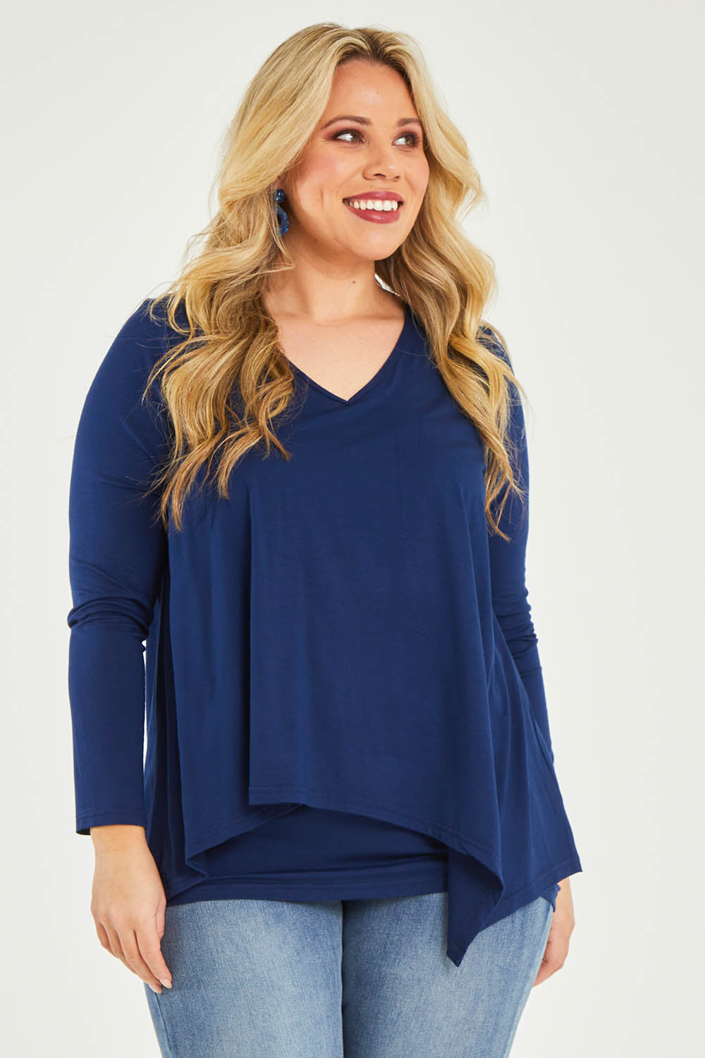 Model Katie wearing size 16 of the Belle V Neck Forgiver Tunic in colour Navy (Blue), from the front, cropped image