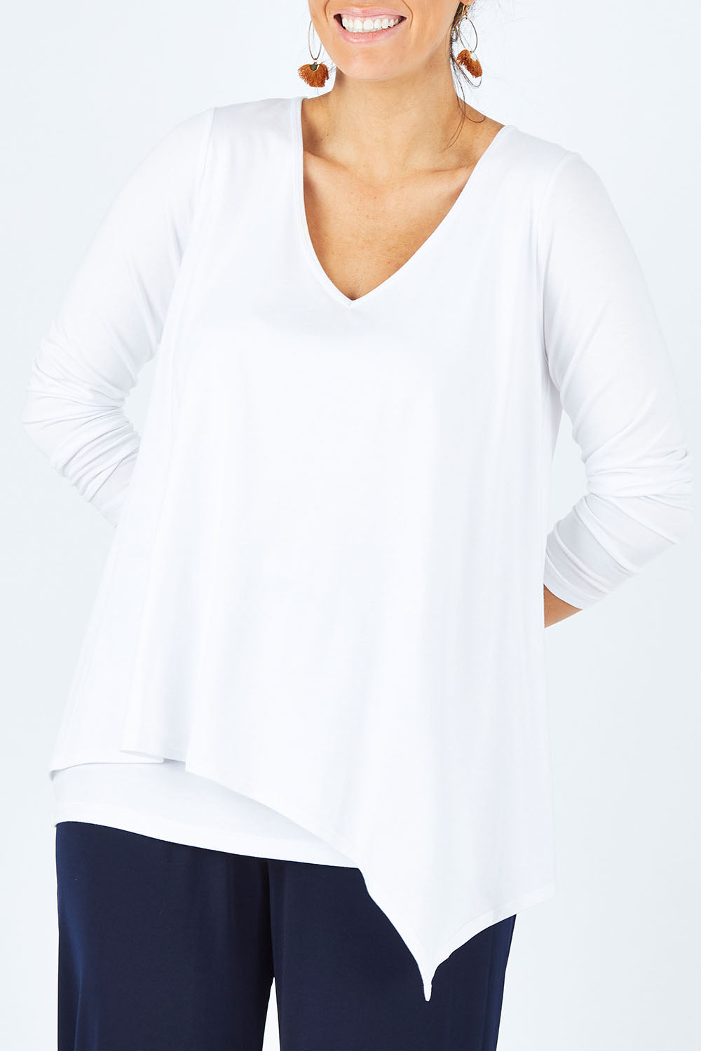 Model Laura wearing size 12 of the Belle V Neck Forgiver Tunic in colour White (White), from the front, cropped image