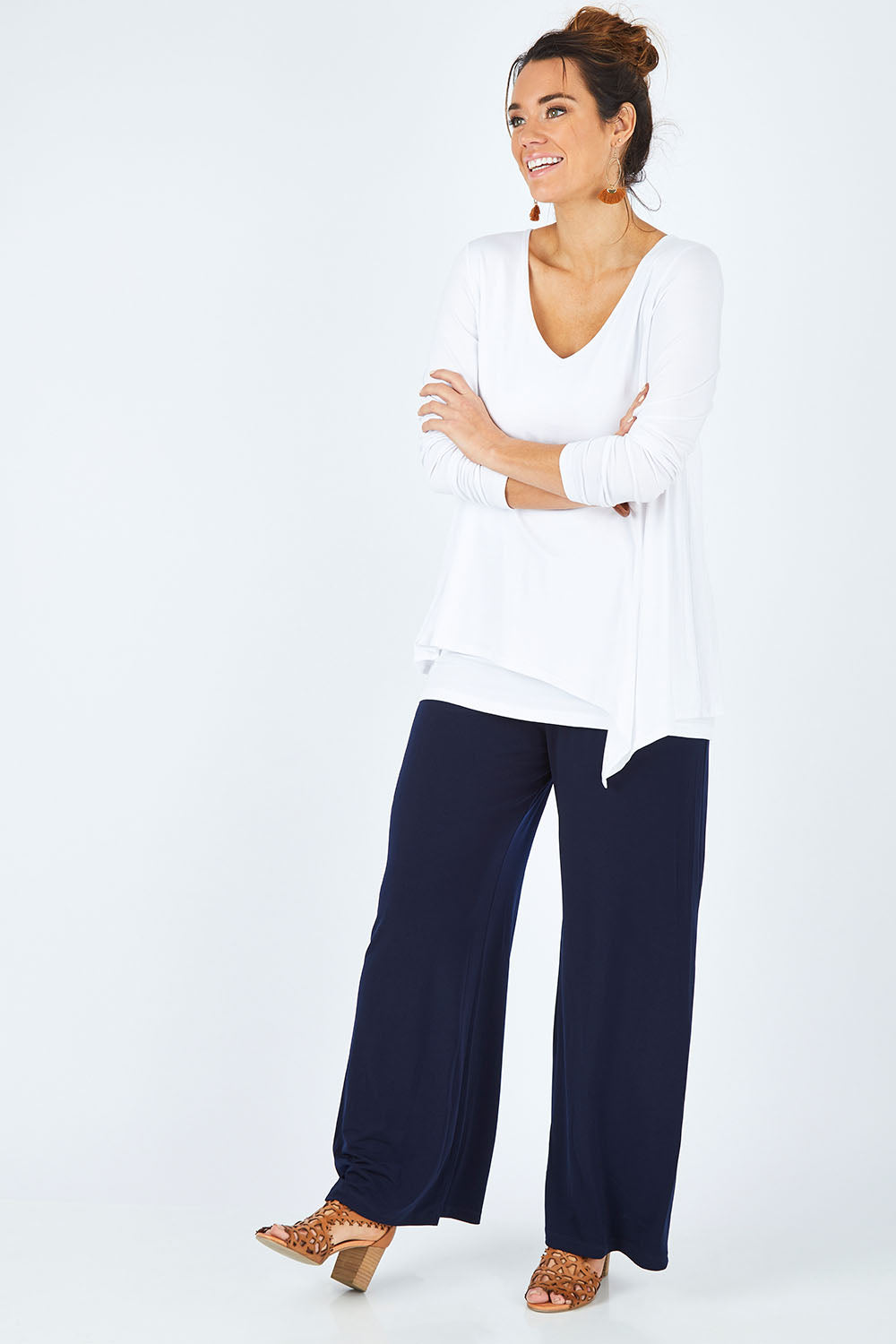 Model Laura wearing size 12 of the Belle V Neck Forgiver Tunic in colour White (White), from the front, showing the whole outfit