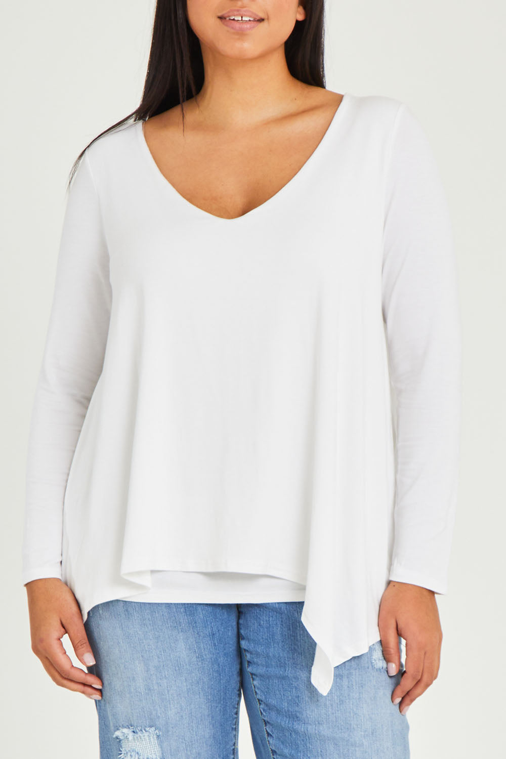 Model Terri-Leigh wearing size 14 of the Belle V Neck Forgiver Tunic in colour White (White), from the front, cropped image
