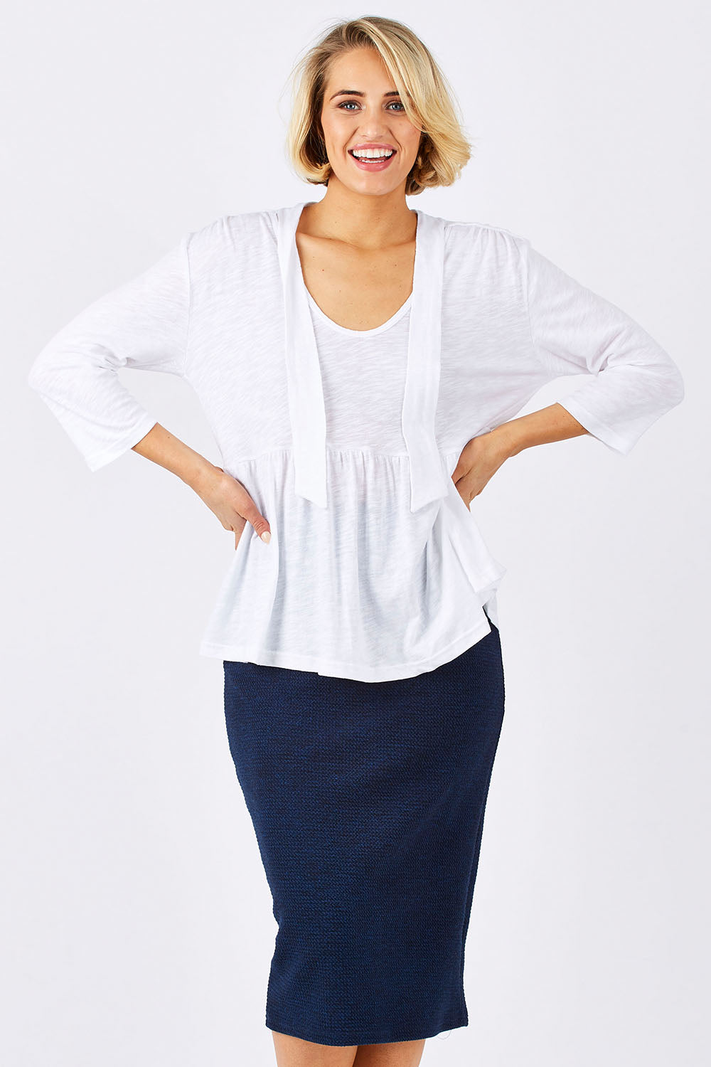 Model Emma wearing size 10 of the Belle Textured Pencil Skirt in colour Navy (Blue), from the front, cropped image