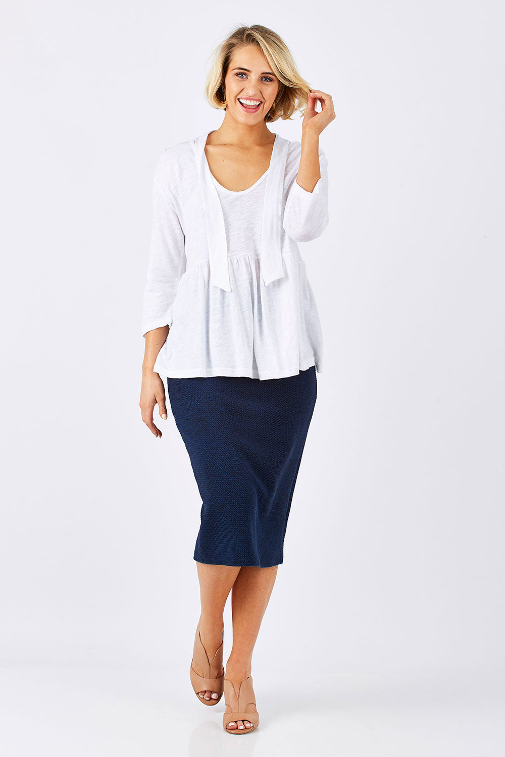 Model Emma wearing size 10 of the Belle Textured Pencil Skirt in colour Navy (Blue), from the front, showing the whole outfit
