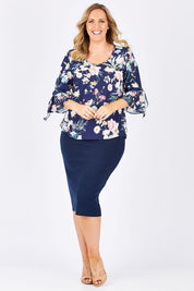 Model Jess wearing size 14 of the Belle Textured Pencil Skirt in colour Navy (Blue), from the front, showing the whole outfit