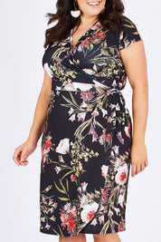 Model Mae wearing size 18 of the Belle Orange Blossom Wrap Dress in colour BlosPrint, from the front, cropped image