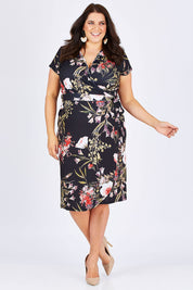 Model Mae wearing size 18 of the Belle Orange Blossom Wrap Dress in colour BlosPrint, from the front, showing the whole outfit