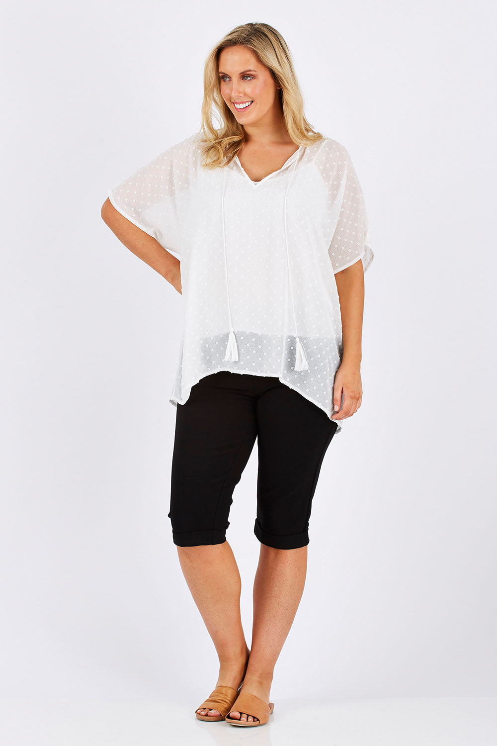 Model Jess wearing size 12 of the Belle Knee Short in colour Black (Black), from the front, showing the whole outfit