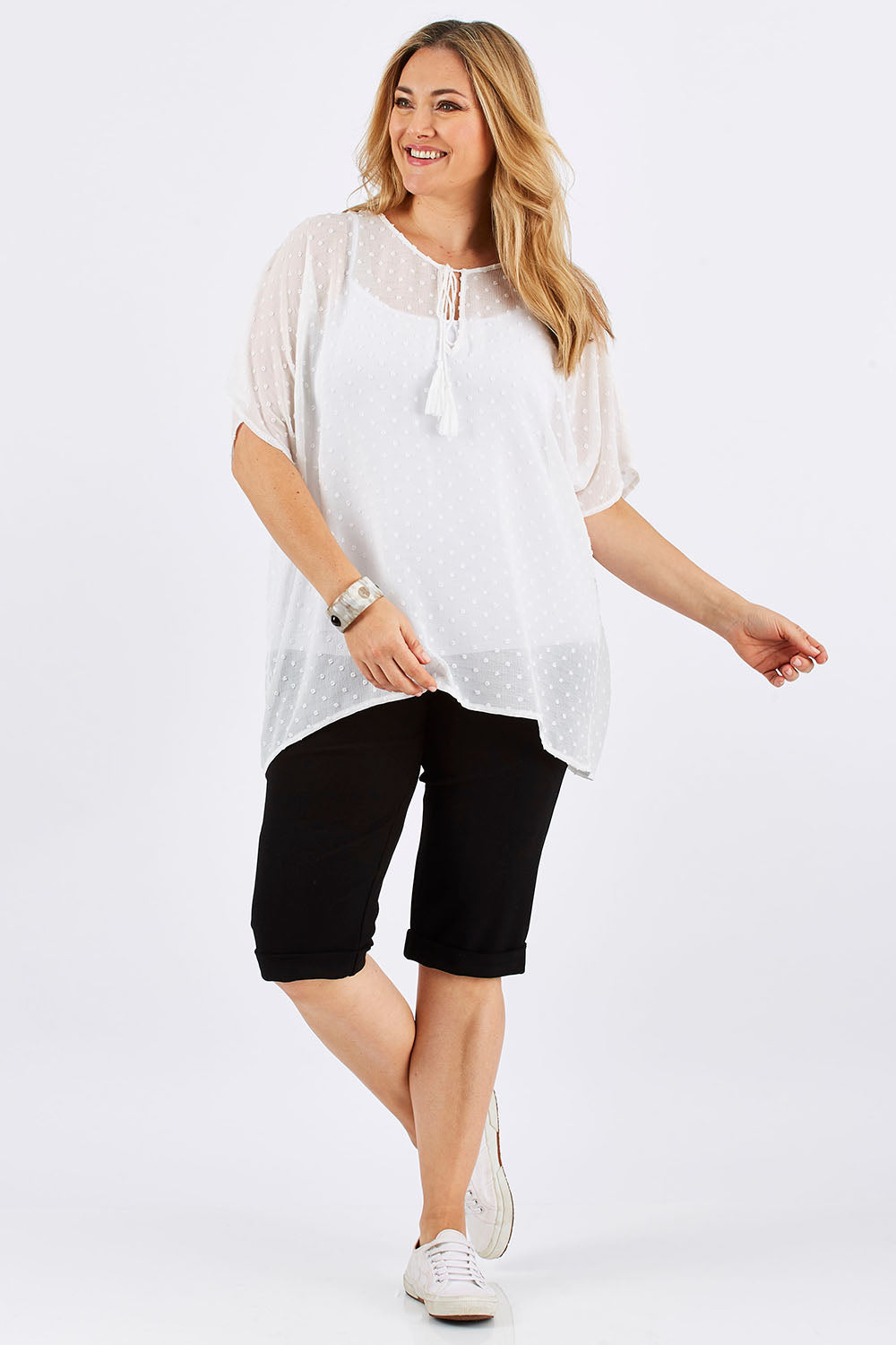 Model Ljubenka wearing size 16 of the Belle Knee Short in colour Black (Black), from the front, showing the whole outfit