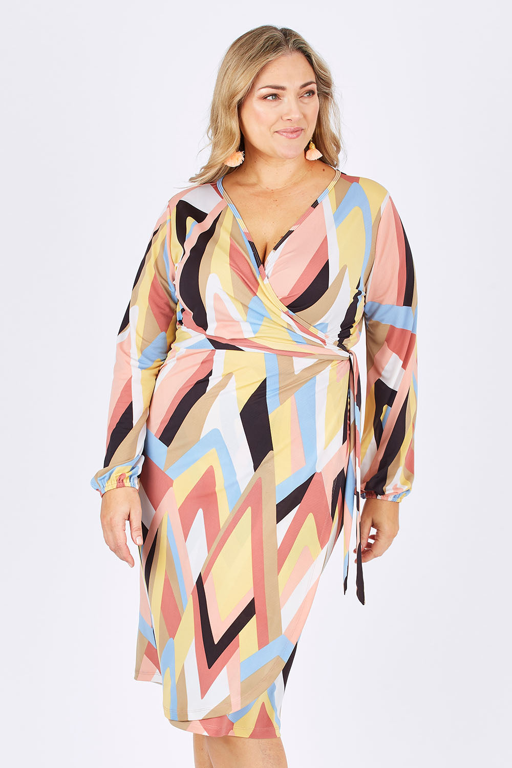 Model Ljubenka wearing size 16 of the Belle Pastel Geometric Wrap Dress in colour Pastel, from the front, cropped image