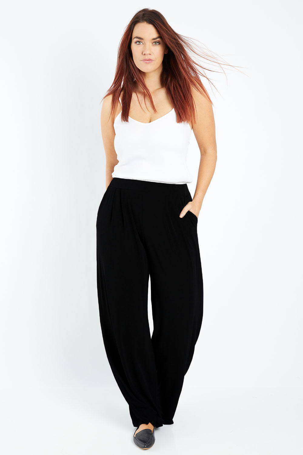 Model Laura wearing size 12 of the Belle Wide Leg Pant in colour Black (Black), from the front, showing the whole outfit