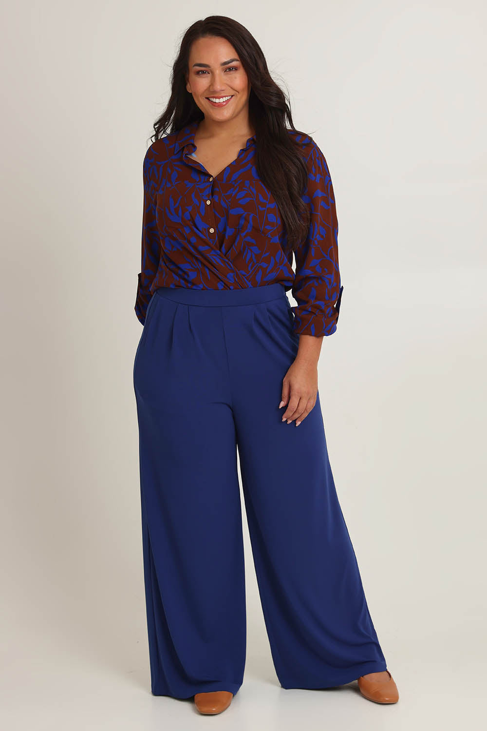 Model Ashleigh wearing size 16 of the Belle Wide Leg Pant in colour Frenchnavy (Blue), from the front, cropped image