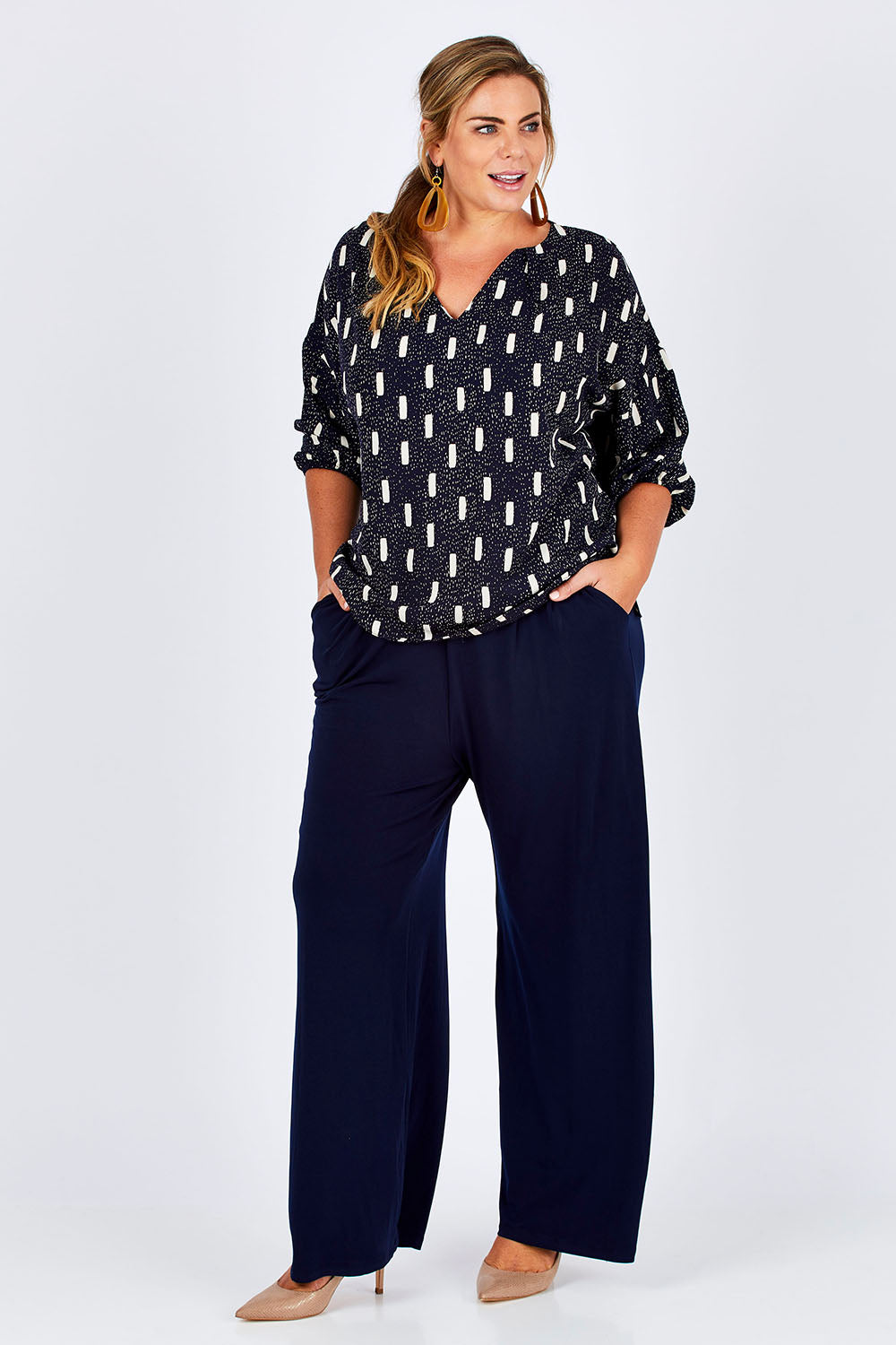 Model Fiona wearing size 16 of the Belle Wide Leg Pant in colour Navy (Blue), from the front, showing the whole outfit