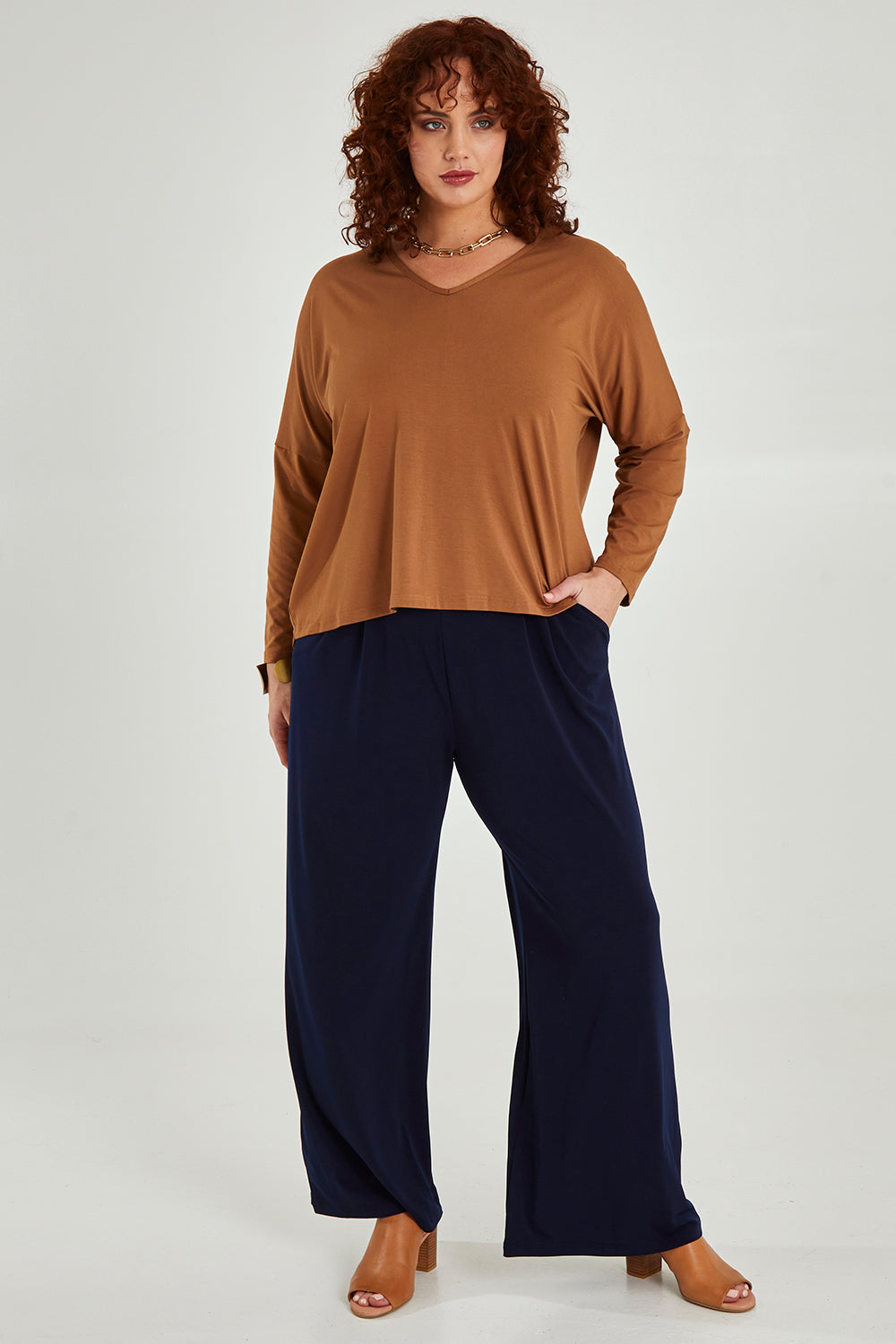 Model Maddy wearing size 16 of the Belle Wide Leg Pant in colour Navy (Blue), from the front, showing the whole outfit