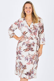 Model Jess wearing size 12 of the Belle Crepe Wrap Dress in colour Leaf (White), from the front, cropped image