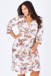 Model Lauren wearing size 16 of the Belle Crepe Wrap Dress in colour Leaf (White), from the front, cropped image