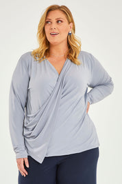 Model Caitlin wearing size 20 of the Belle Drape Tee in colour Sliver (Grey), from the front, cropped image