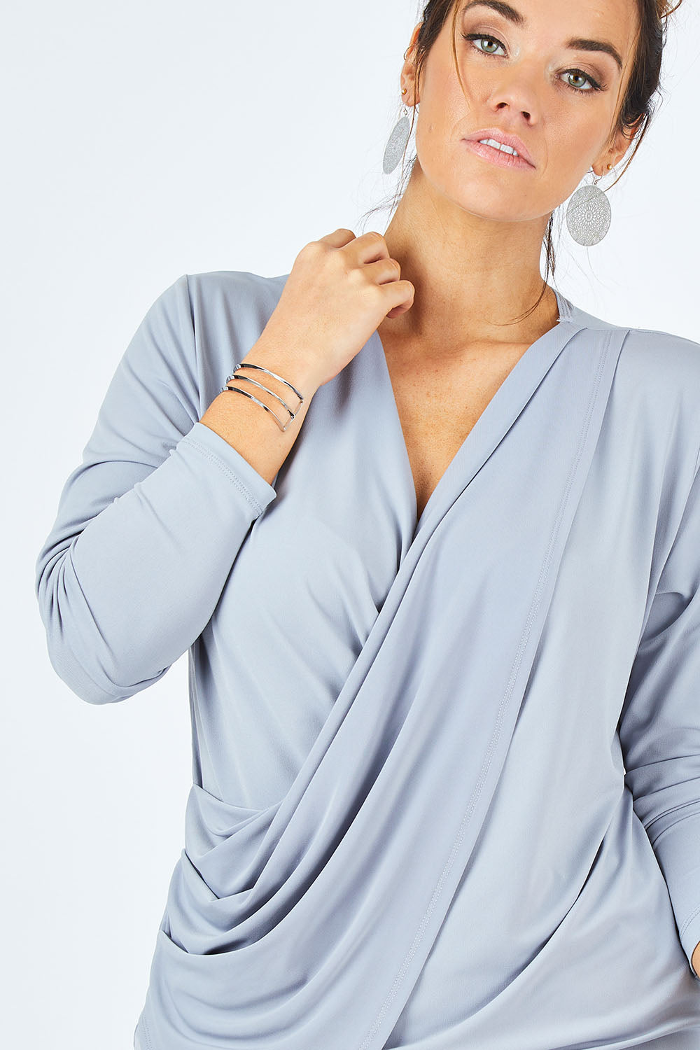 Model Laura wearing size 12 of the Belle Drape Tee in colour Sliver (Grey), from the front, cropped image