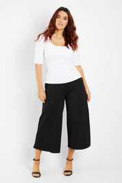 Model Laura wearing size 12 of the Belle Palazzo Ponte Crop in colour Black (Black), from the front, showing the whole outfit