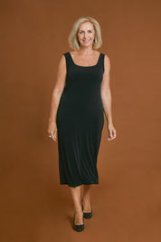 Model Sandy wearing size 10 of the Belle Basic Slip Dress in colour Black (Black), from the front, showing the whole outfit