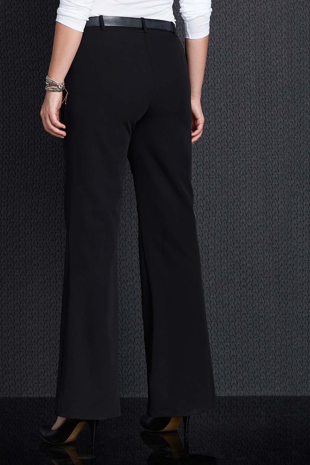 A model wearing size 12 of the Belle Suit Pants in colour Black (Black), from the back