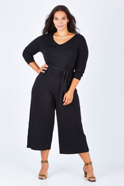 Model Lauren wearing size 16 of the Belle 7/8 Sleeve Knit Jumpsuit With Self Belt in colour Black (Black), from the front, showing the whole outfit