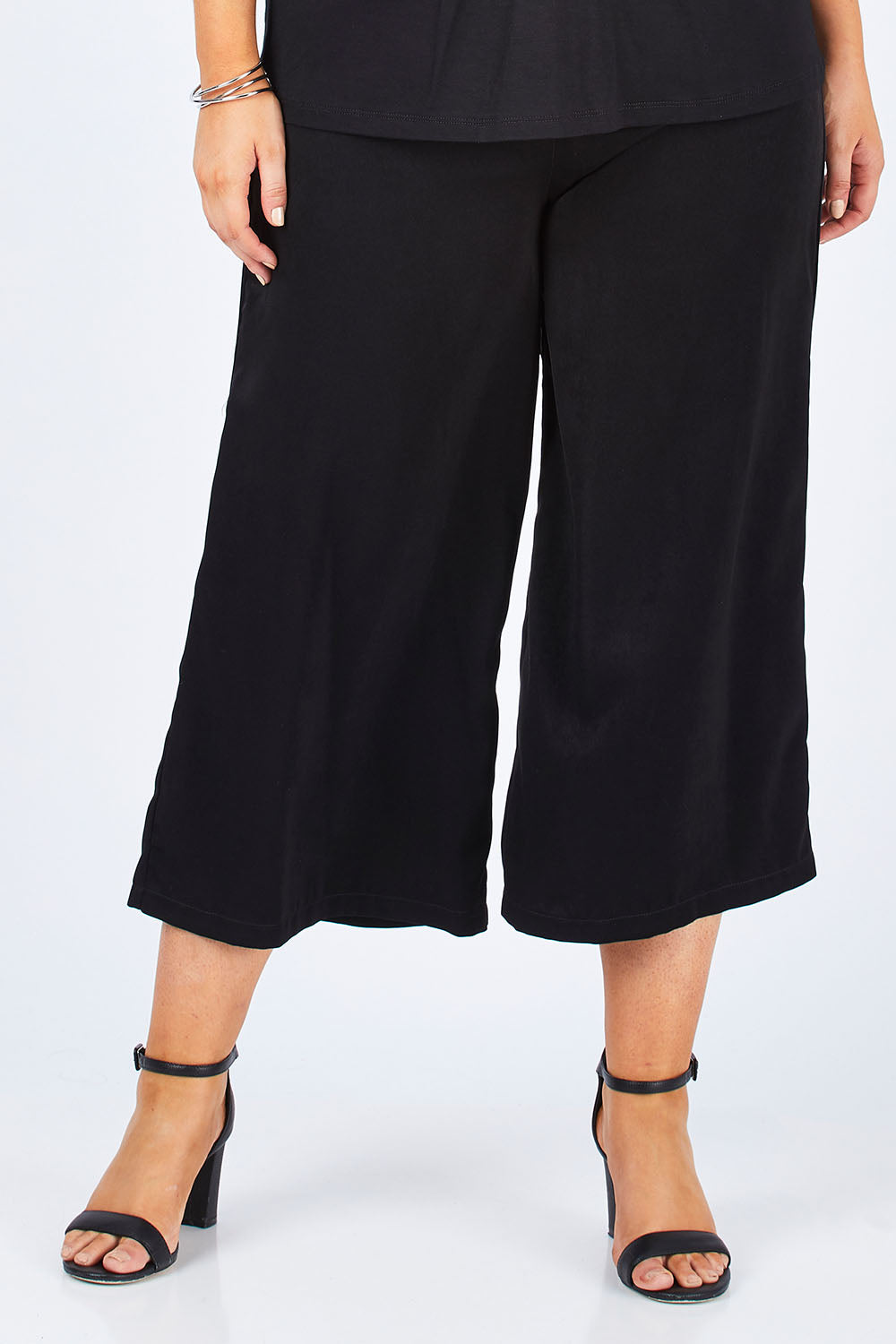 Model Jess wearing size 12 of the Belle Dress Pant in colour Black (Black), from the front, cropped image