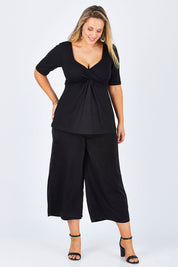 Model Jess wearing size 12 of the Belle Dress Pant in colour Black (Black), from the front, showing the whole outfit