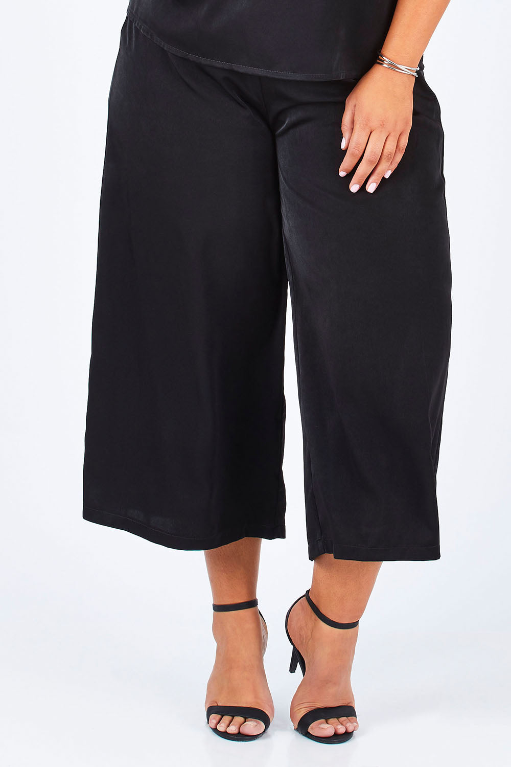 Model Lauren wearing size 16 of the Belle Dress Pant in colour Black (Black), from the front, cropped image