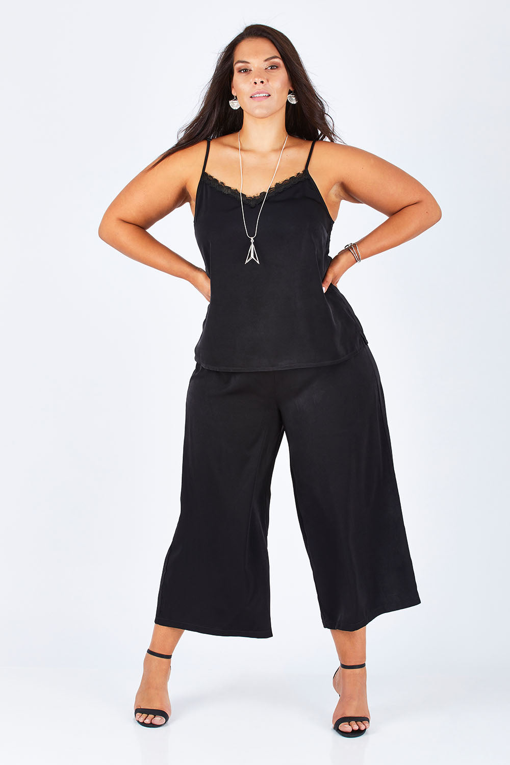 Model Lauren wearing size 16 of the Belle Dress Pant in colour Black (Black), from the front, showing the whole outfit