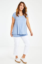 Model Laura wearing size 12 of the Belle New Cap Sleeve Forgiver Tee in colour Chambray (Blue), from the front, showing the whole outfit