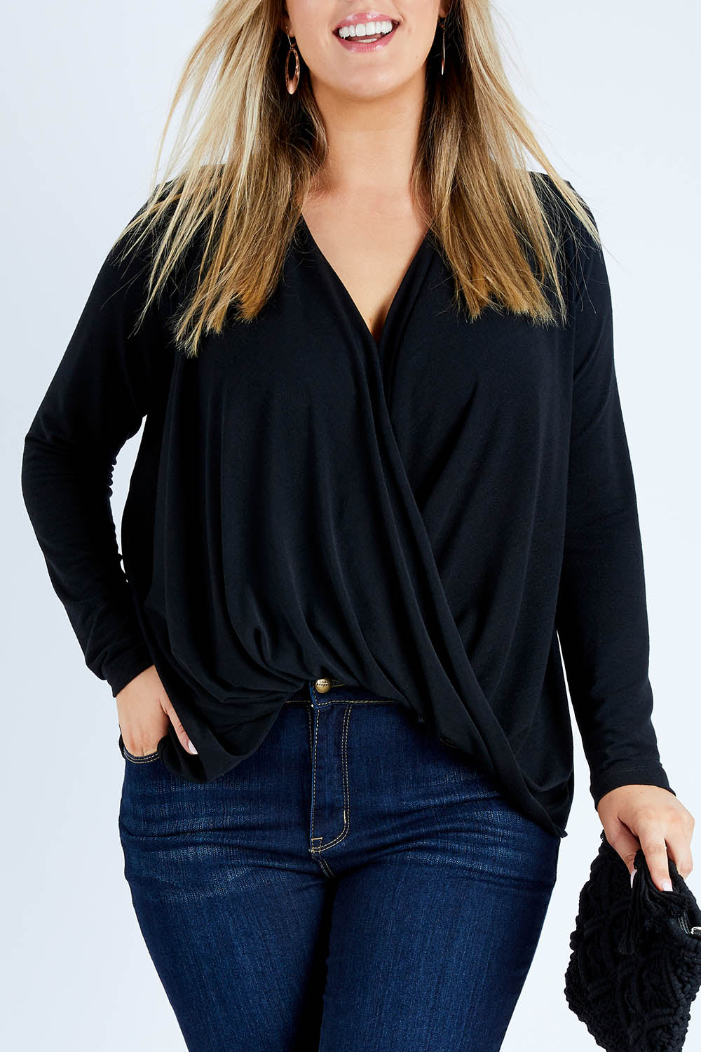 Model Jess wearing size 12 of the Belle High Low Knit in colour Black (Black), from the front, cropped image