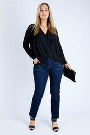 Model Jess wearing size 12 of the Belle High Low Knit in colour Black (Black), from the front, showing the whole outfit