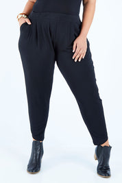 Model Lauren wearing size 16 of the Belle Taper Pant in colour Black (Black), from the front, cropped image