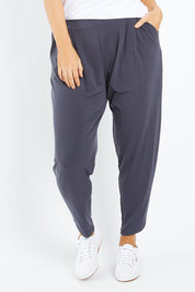 Model Laura wearing size 12 of the Belle Taper Pant in colour Charcoal (Grey), from the front, cropped image