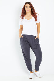 Model Laura wearing size 12 of the Belle Taper Pant in colour Charcoal (Grey), from the front, showing the whole outfit