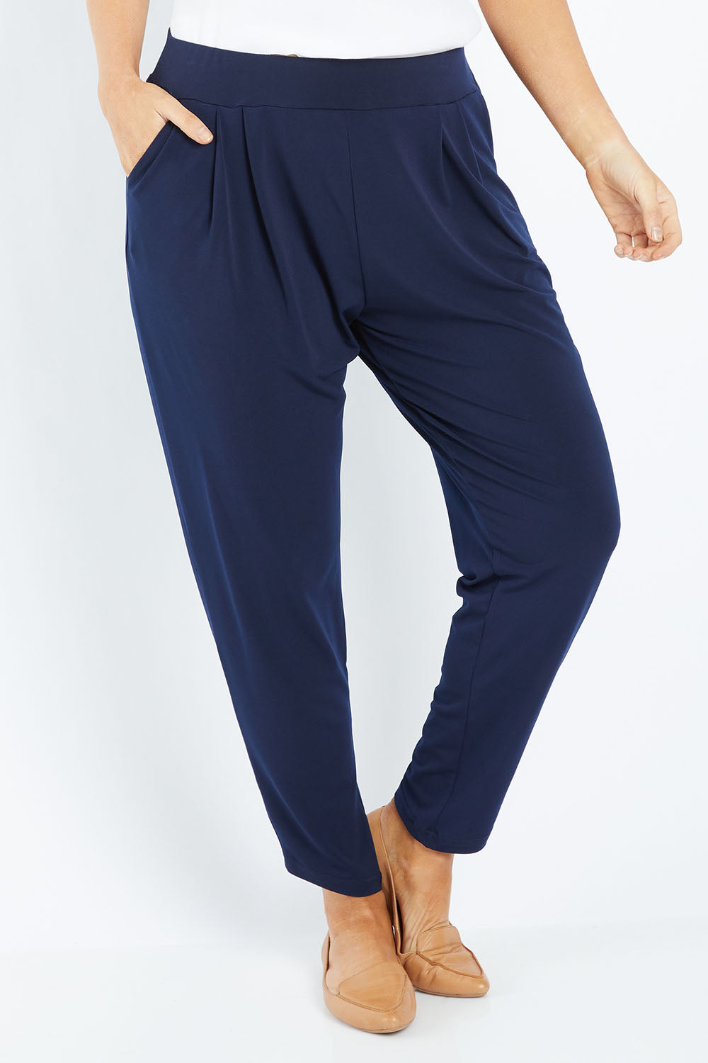 Model Laura wearing size 12 of the Belle Taper Pant in colour Navy (Blue), from the front, cropped image
