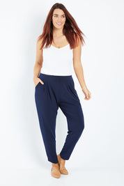 Model Laura wearing size 12 of the Belle Taper Pant in colour Navy (Blue), from the front, showing the whole outfit