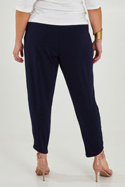 Model Maddy wearing size 16 of the Belle Taper Pant in colour Navy (Blue), from the back