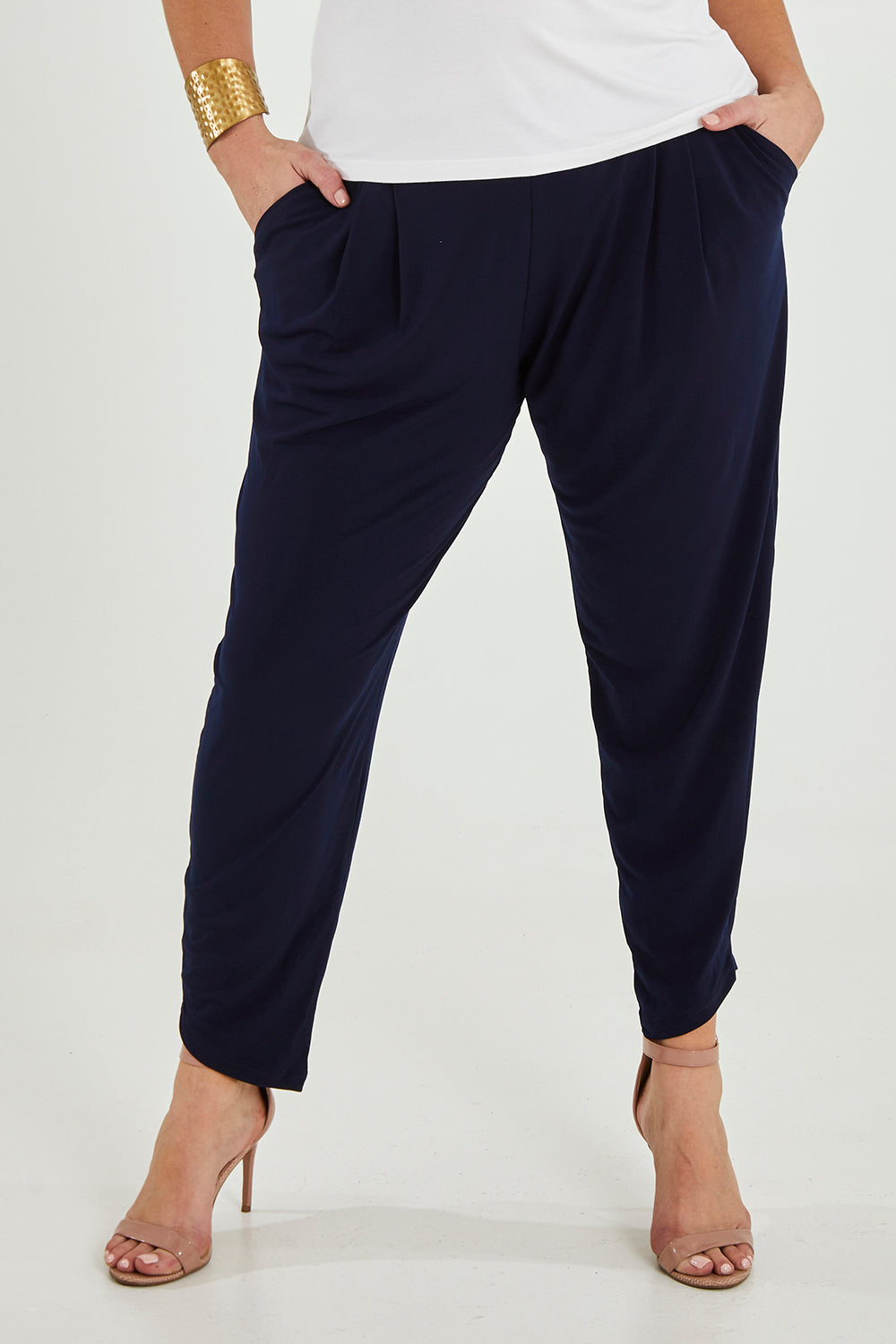 Model Maddy wearing size 16 of the Belle Taper Pant in colour Navy (Blue), from the front, cropped image