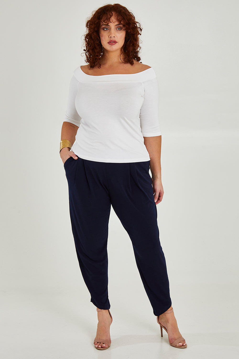 Model Maddy wearing size 16 of the Belle Taper Pant in colour Navy (Blue), from the front, showing the whole outfit