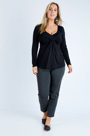 Model Jess wearing size 12 of the Belle Long Sleeve Cross Front Tee in colour Black (Black), from the front, showing the whole outfit