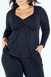 Model Lauren wearing size 16 of the Belle Long Sleeve Cross Front Tee in colour Black (Black), from the front, cropped image