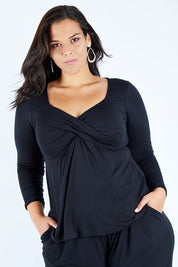 Model Lauren wearing size 16 of the Belle Long Sleeve Cross Front Tee in colour Black (Black), from the front, cropped image