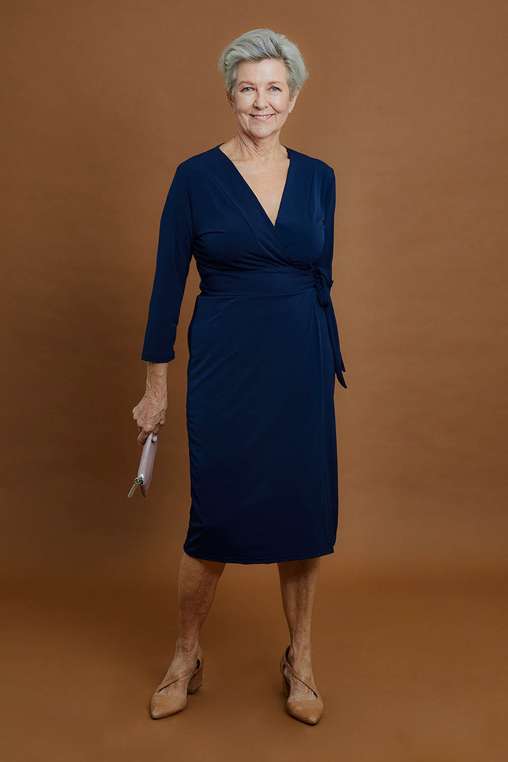 Model Elise wearing size 10 of the Belle Basic Wrap Dress in colour Navy (Blue), from the front, showing the whole outfit