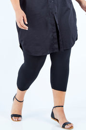 Model Lauren wearing size 16 of the Belle 3/4 Legging in colour Black (Black), from the front, cropped image