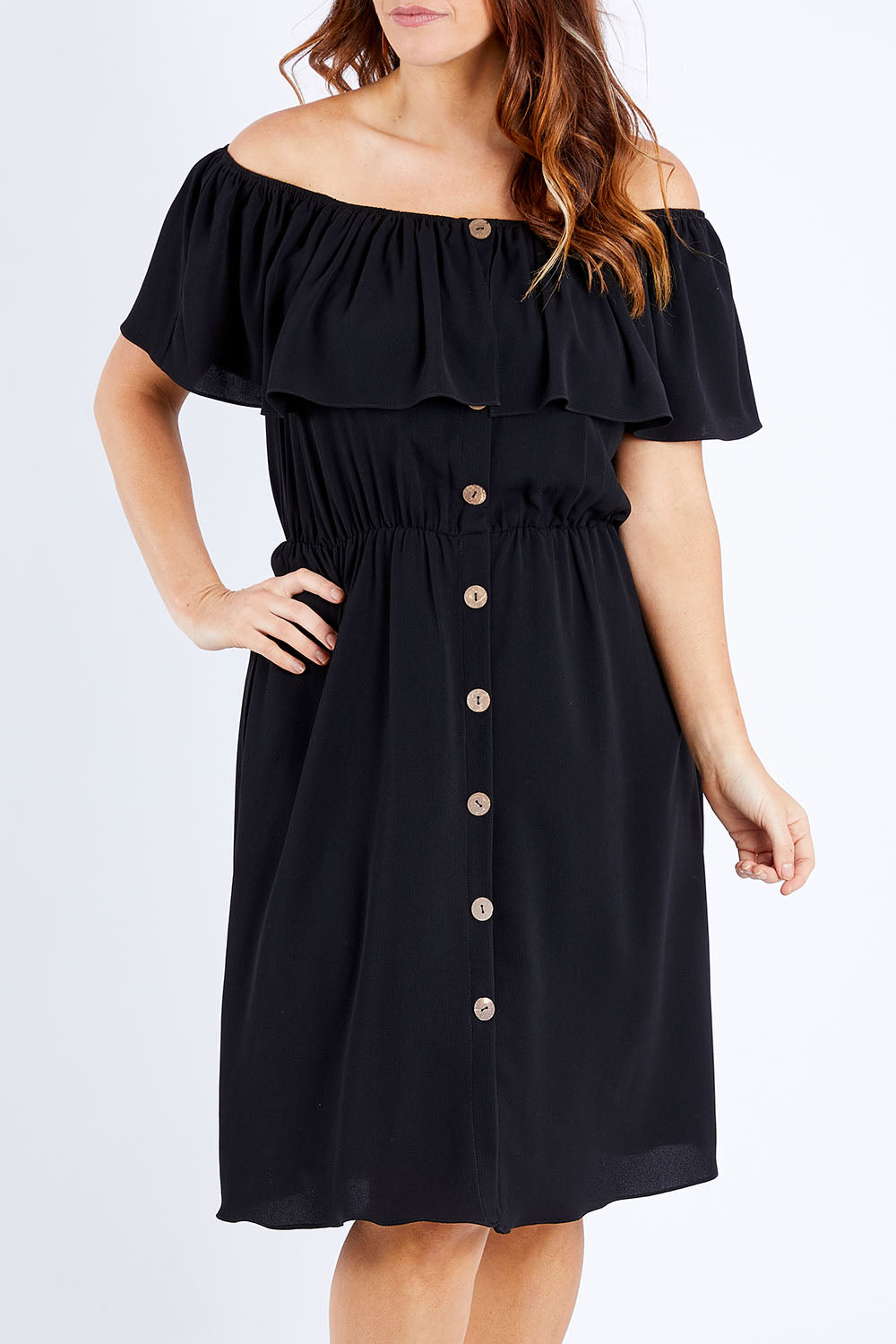 Model Laura wearing size 12 of the Belle Off Shoulder Button Through Dress in colour Black (Black), from the front, cropped image