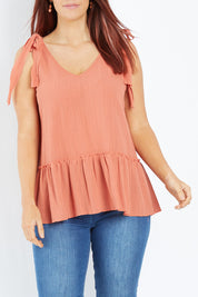 Model Laura wearing size 12 of the Belle Tie Shoulder Top in colour Clay, from the front, cropped image