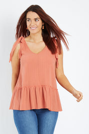 Model Laura wearing size 12 of the Belle Tie Shoulder Top in colour Clay, from the front, cropped image