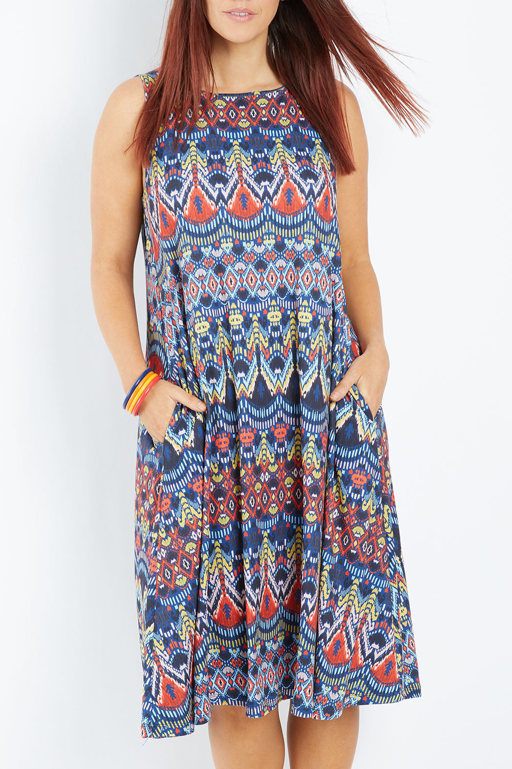Model Laura wearing size 14 of the Belle Aztec Trapeze Dress in colour Aztec (Red), from the front, cropped image