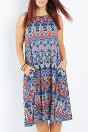 Model Laura wearing size 14 of the Belle Aztec Trapeze Dress in colour Aztec (Red), from the front, cropped image