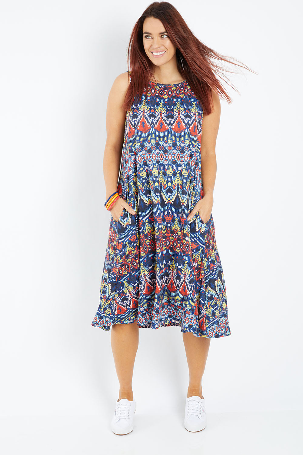 Model Laura wearing size 14 of the Belle Aztec Trapeze Dress in colour Aztec (Red), from the front, showing the whole outfit